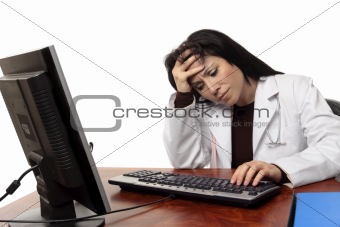 Overworked tired doctor at computer