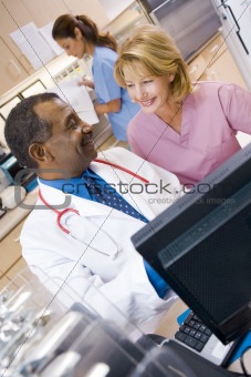 A Doctor And Nurse Discussing Something At The Reception Area Of