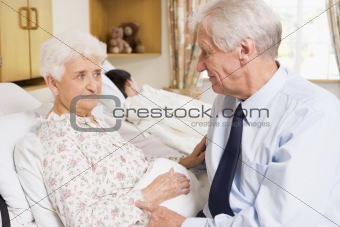 Senior Man Sitting With His Wife In Hospital
