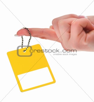 hand holding yellow price tag