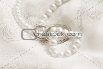 Wedding background: pearls and wedding bangs. Toning in sepia.