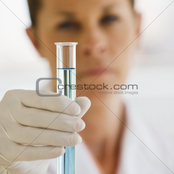 Female Scientist holding up Test Tube