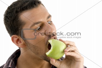 man eating green apple  