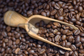 Close-up macro coffee beans wooden scoope