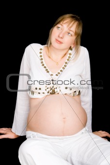 A pregnant lady sitting on the floor