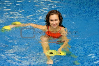 Woman in water with dumbbels
