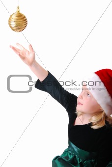 Girl reaching for ornament