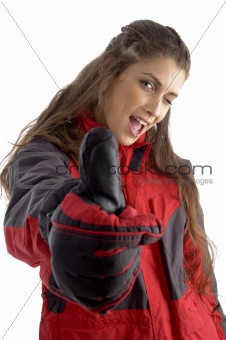 caucasian woman with winked eye showing thumbs up