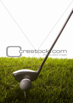 Golf ball on tee with club