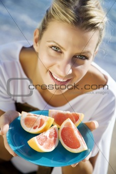 woman with pink grapefruit