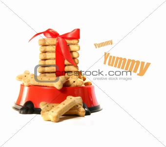 Dog biscuits in bowl with red bow
