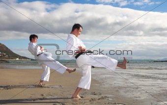 Men practicing Karate on the beach