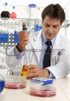 Scientist taking sample with pipette