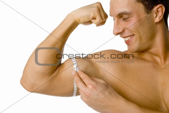 Man's mesuring his biceps