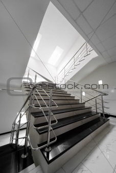Marble staircase with a steel handrail