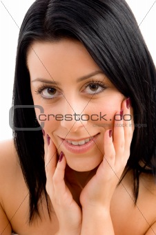 close up of smiling young female against white background