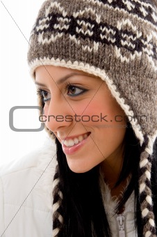 side pose of smiling woman wearing woolen cap on white backgroun