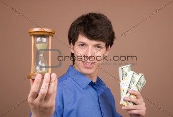 Young businessman with sand-glass and money