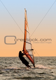 Silhouette of a windsurfer on a gulf 