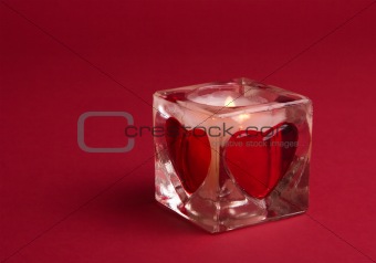 Candle with valentines on the red background