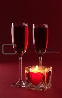 Wineglasses and candle on the white background
