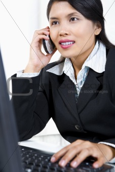 Young Asian businesswoman is on phone