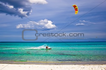kitesurfer and white sandy beach