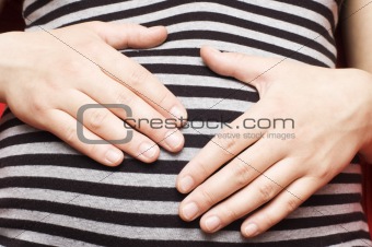 pregnant woman in black and white stripped t-shirt