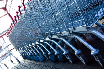 business - shopping with red handles trolleys outside supermarket