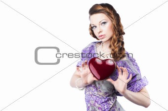 Beautiful romantic woman holding a dark red heart