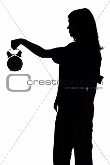 silhouette of woman with alarm clock