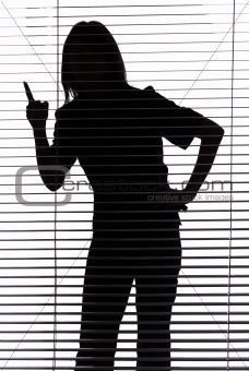 silhouette of woman threatens by finger