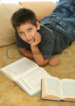 Boy reading  books on the floor