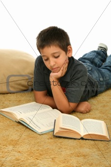 Boy reading  books on the floor