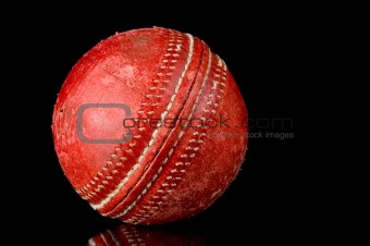 Red Cricket ball on black background
