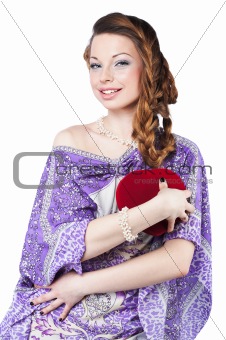 Beautiful romantic woman holding a red heart, isolated on white