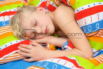 Sleeping child on the bed