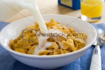 pouring milk into cereal bowl