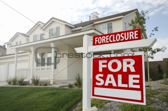 Foreclosure Home For Sale Sign and House with Dramatic Sky Background.