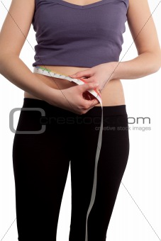 Attractive Woman measuring herself with a tape