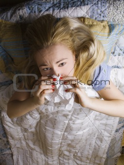 sick woman lying in bed