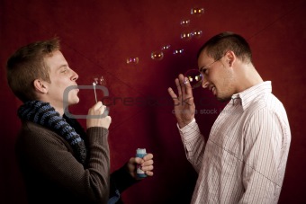 Young Man Blowing a Bubbles at Friend