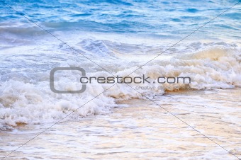 Waves breaking on tropical shore