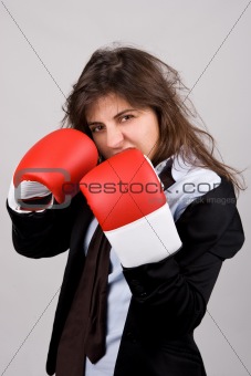 businesswoman wearing boxing gloves with confident attitude