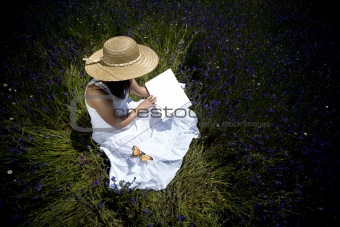 young woman in white dress reading book outdoors