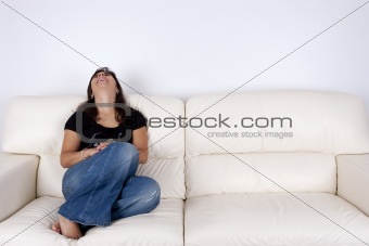 beautiful young woman sitting in white sofa smiling