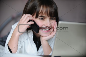 child on lap top and phone