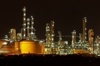 Towers and silos of a chemical production facility at night