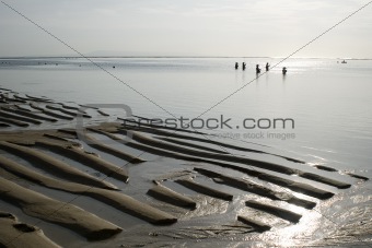 Fishermen on ocean beach, outflow, morning, Indonesia