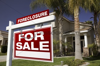 Foreclosure For Sale Real Estate Sign in Front of House.